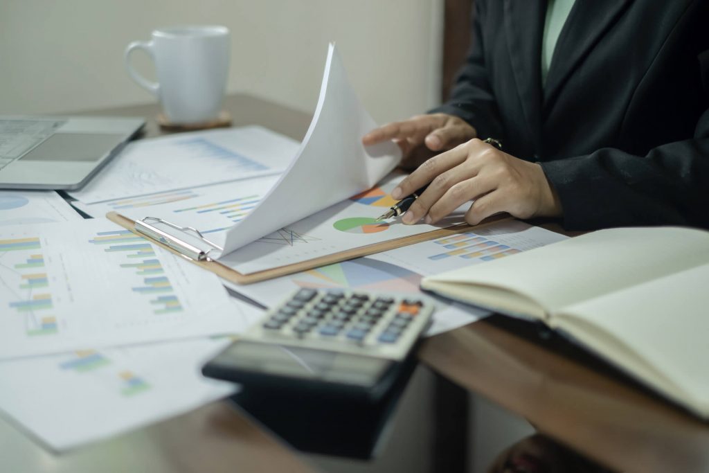 Accountant checking paperwork at their desk | Featured image for the Business Accounting Services page from Taggart & Partners.